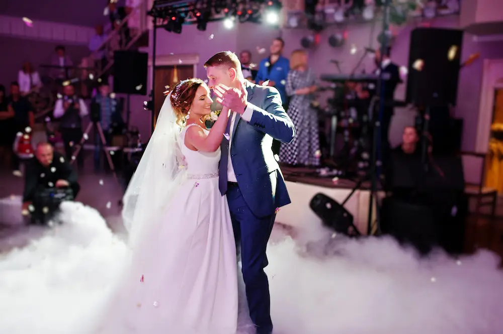 a man and woman dancing on a stage after weeding