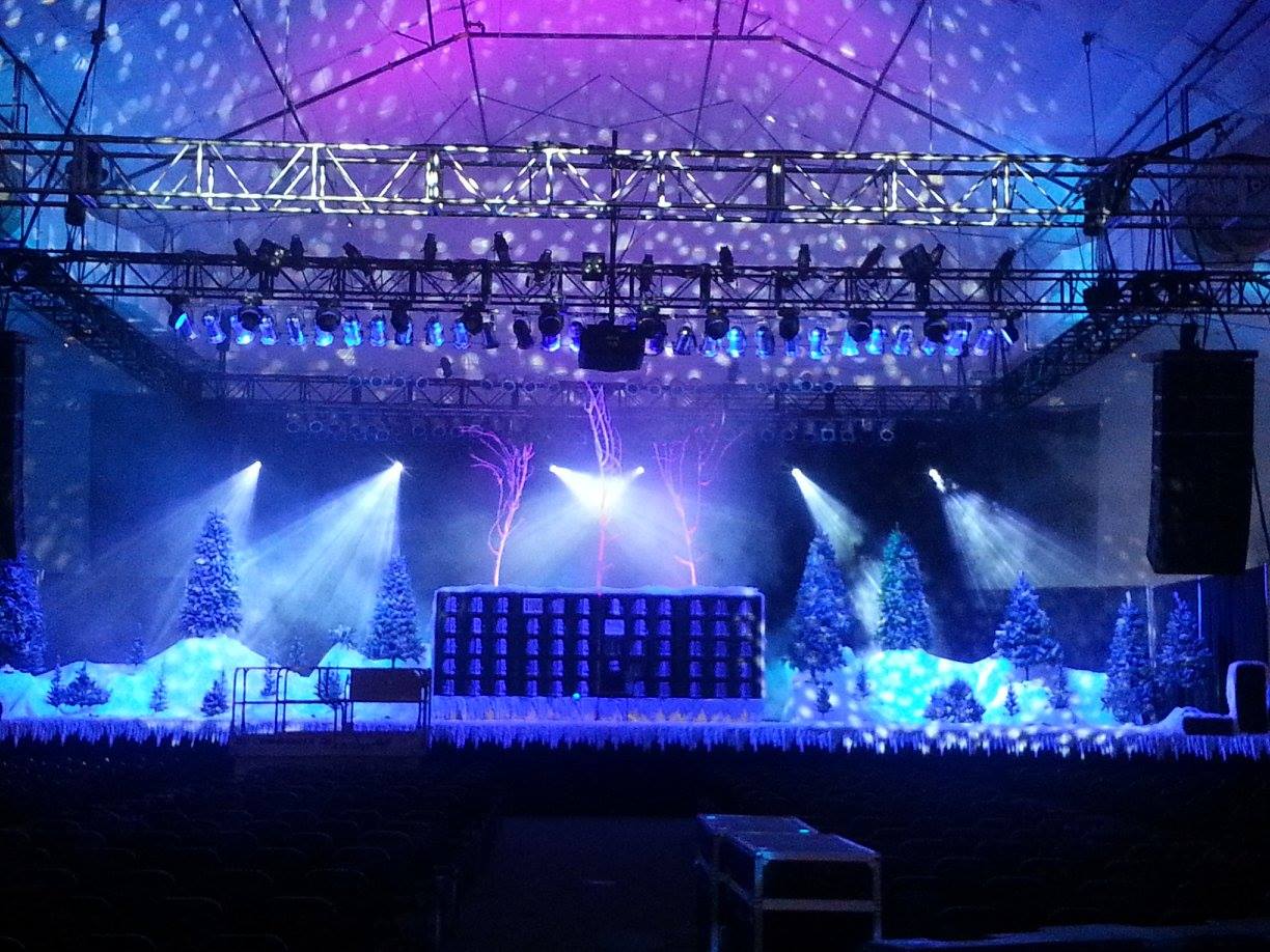 a stage with lights and trees